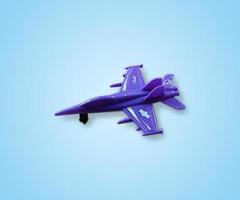fighter jet airplane toy isolated on blue white gradient background photo