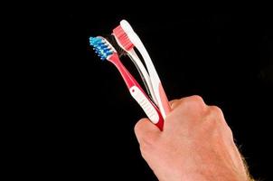 Hand holding toothbrushes photo