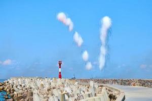 White carbon fiber clouds in blue sky hiding naval destroyers from anti-ship missiles, military show photo