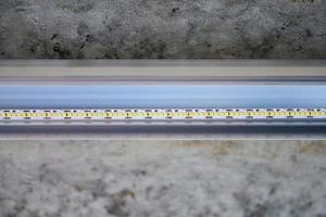 LED strip with aluminum profile on rough ceiling photo