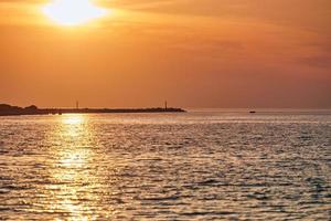 Calm sea with sunset sky, beautiful scenic view, amazing dramatic rising sun reflected in water photo