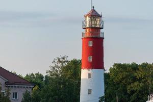 Lighthouse in seaport. Beautiful russian Baltiysk beacon. Scenery blue sky, copy space. photo