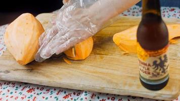 The chef cuts the sweet potatoes into slices. Romantic atmosphere in the background video