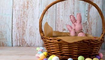 Easter banner with basket with toy bunnies and eggs. Place for text photo