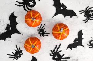 Halloween card with spiders,pumpkins and bats. Selective colors. October 31 concept. Banner in white,orange and black colors. photo