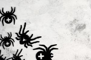 Halloween flat lay banner with spiders on concrete background with place for text. photo