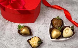 Heart shaped box with assorted chocolate covered strawberries on a gray background.St Valentine's day concept photo