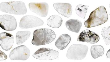 Rutilated quartz jewel stones set texture on white light isolated background. Moving right seamless loop backdrop. video