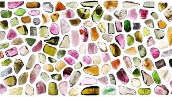 Tourmaline jewel stones set texture on white light isolated background. Moving right seamless loop backdrop. video
