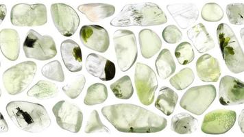 Prehnite jewel stones set texture on white light isolated background. Moving right seamless loop backdrop. video