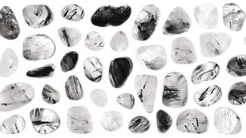 Tourmalinated quartz stones set texture on white light isolated background. Moving right seamless loop backdrop. video