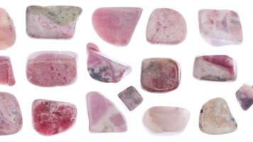 Rhodochrosite jewel stones set texture on white light isolated background. Moving right seamless loop backdrop. video