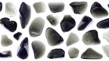 Obsidian jewel stones set texture on white light isolated background. Moving right seamless loop backdrop. video