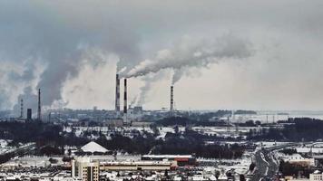 aerial winter view on smoked pipes of chemical enterprise plant. Air pollution concept. Industrial winter landscape environmental pollution waste of thermal power plant video