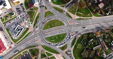 aerial view and circular motion over  crossroads on road junction with heavy traffic in city video