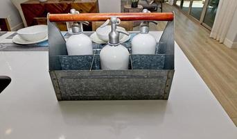 Kitchen Counter With Metal Tray Of Seltzer Bottles photo