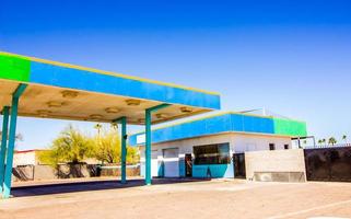 Old Abandoned Garage Building With Drive In Doors And  Overhang photo