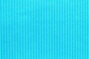 Abstract paper blue and aquamarine geometric symmetrical texture striped surface vertical lines background. Structure design cardboard shape backdrop. Decoration interior concept. Flatlay, close-up photo