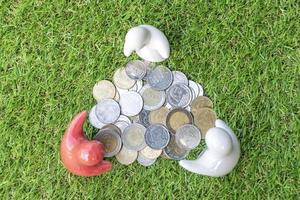 Top view mock up family statue and coins on grass floor with white background photo