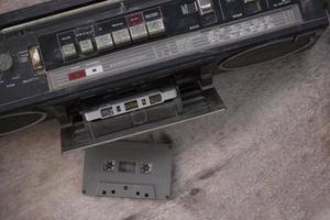 Top view retro radio and cassette tape on wooden floor photo