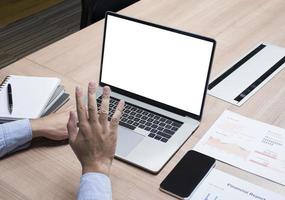 Businessman raise your hand with white screen background mock up on display laptop with clipping path photo