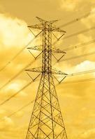 High voltage pole with yellow sky background photo