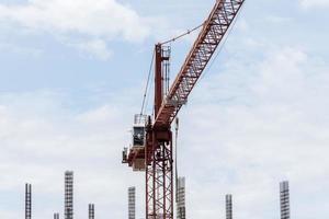 grúa de construcción de torre en el sitio de construcción de edificios con fondo de cielo azul foto