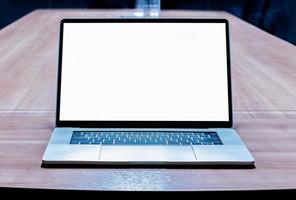 Mock up white screen display laptop on table in meeting room photo