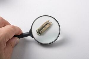 Bullet under magnifying glass as Conceptual against the war photo