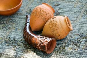 Harden clay pot and horn showing for sale photo