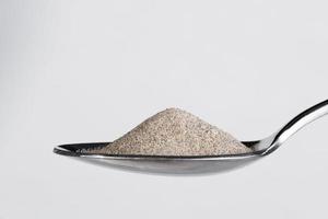 Ground White Pepper on a Spoon photo