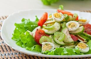 Salad of tomatoes, cucumbers and quail eggs photo