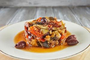 Ratatouille Ragout with zucchini, zucchini, eggplant, peppers and cherry tomatoes. Decorated with olives. French gourmet cuisine photo