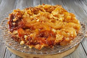 Pie baked with apricots on transparent plate photo