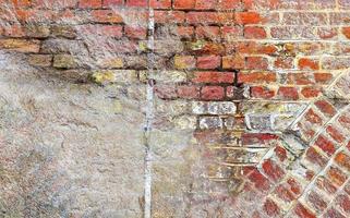 Detailed close up view on very old and weathered brick walls with cracks photo