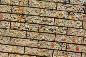 Detailed close up view on very old and weathered brick walls with cracks photo