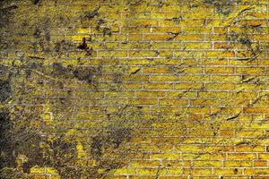 Detailed close up view on very old and weathered brick walls with cracks photo