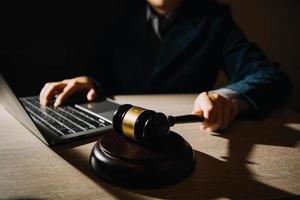 Business and lawyers discussing contract papers with brass scale on desk in office. Law, legal services, advice, justice and law concept picture with film grain effect photo