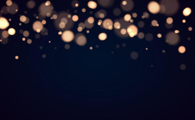 Golden bokeh lights with glowing particles isolated.