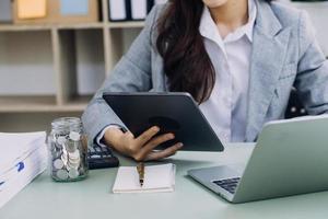 Business team present. Photo professional investor working new startup project. Finance meeting.Digital tablet laptop computer smart phone using, keyboard docking screen foreground,filter