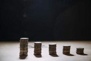 business accounting with saving money with hand putting coins in jug glass concept financial photo