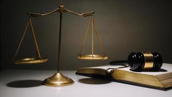 Business and lawyers discussing contract papers with brass scale on desk in office. Law, legal services, advice, justice and law concept photo