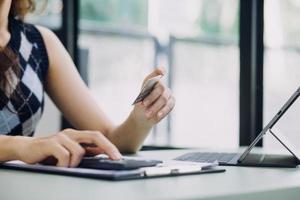 Businessman hand using laptop compter with holding cradit card payments online shopping or business. photo