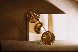 law books and scales of justice on desk in library of law firm. jurisprudence legal education concept. photo