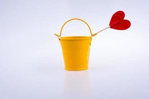 Yellow color bucket and red heart shape photo