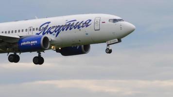 NOVOSIBIRSK, RUSSIAN FEDERATION JULY 15, 2022 - Side view Boeing 737 of Yakutia Airlines landing at Tolmachevo airport. Yakutia Airlines Russian airline video