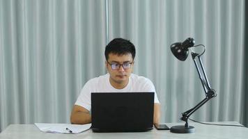 Stressed overwhelmed young businessman in suit working on computer, suffering from eyes fatigue or having painful feelings video