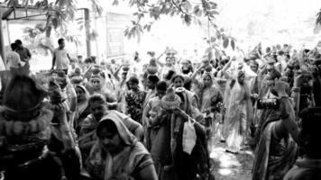 Delhi, India April 03 2022 - Women with Kalash on head during Jagannath Temple Mangal Kalash Yatra, Indian Hindu devotees carry earthen pots containing sacred water with coconut on top-Black and White video