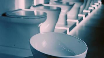 Rotating washbasin. Studio filming. In the background a row of toilets. 4k video