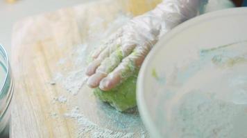 The chef spreads the green dough with a rolling pin. Tortillas prepared and decorated with spinach and beets. Red and green tortillas video